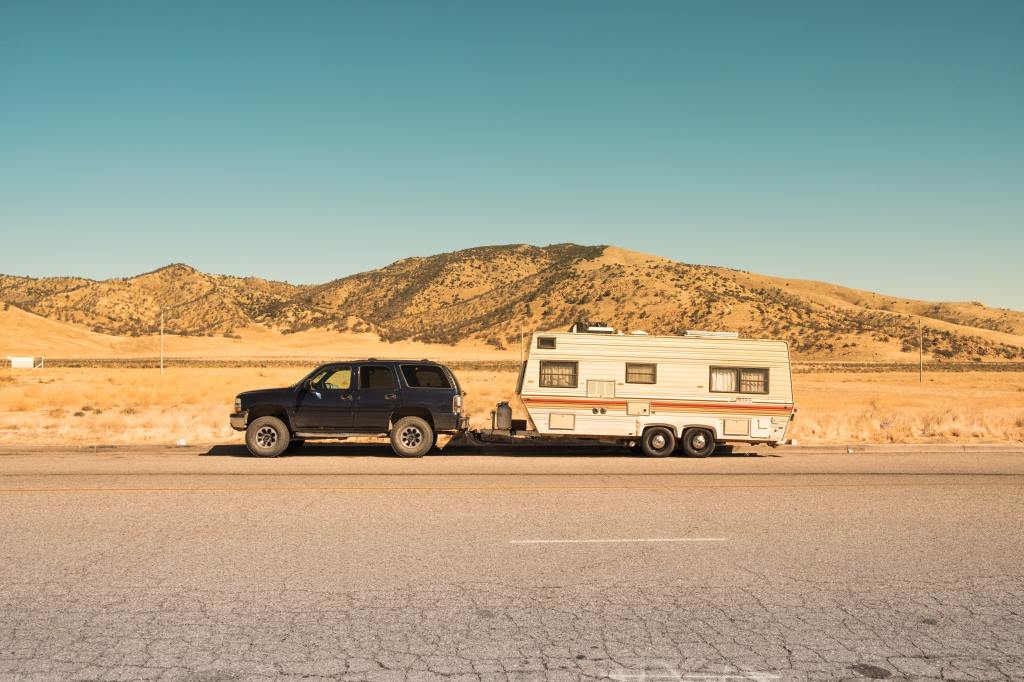 Trailer driving on the open road, representing the outdoors and downhome themes of 2021 Academy Award winning film, Nomadland