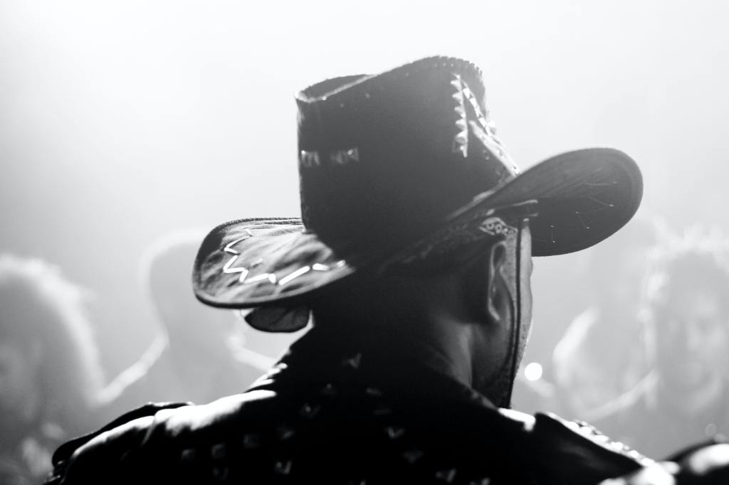 a black man with a cowboy hat, relating to the theme in Django Unchained of black outlaws and historic outlaw figures