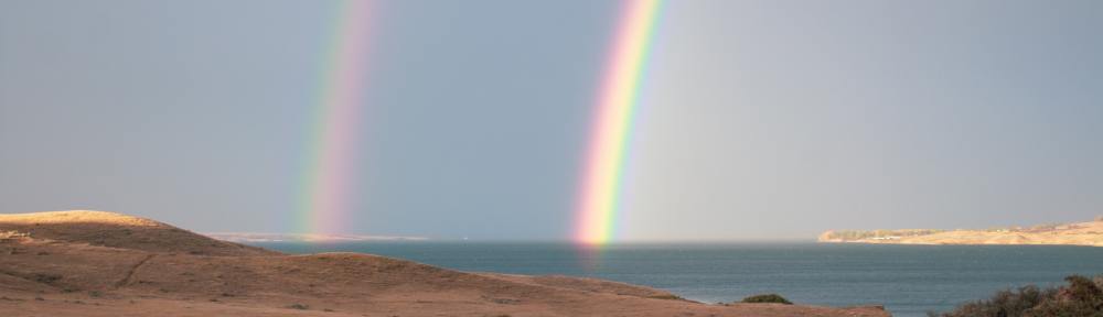 rainbows over lake diefenbaker in rural saskatchewan